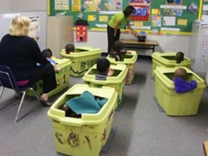 Tubs are Sensory Strategies to provide boundaries for Moderate ASD class during group time activities.